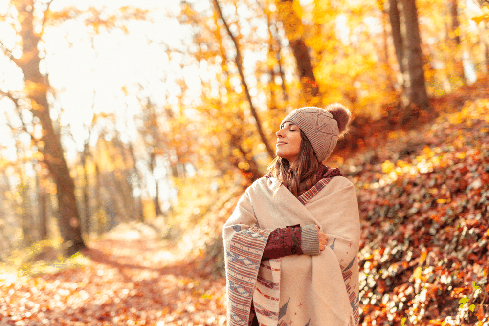 woman walking in forest in the fall