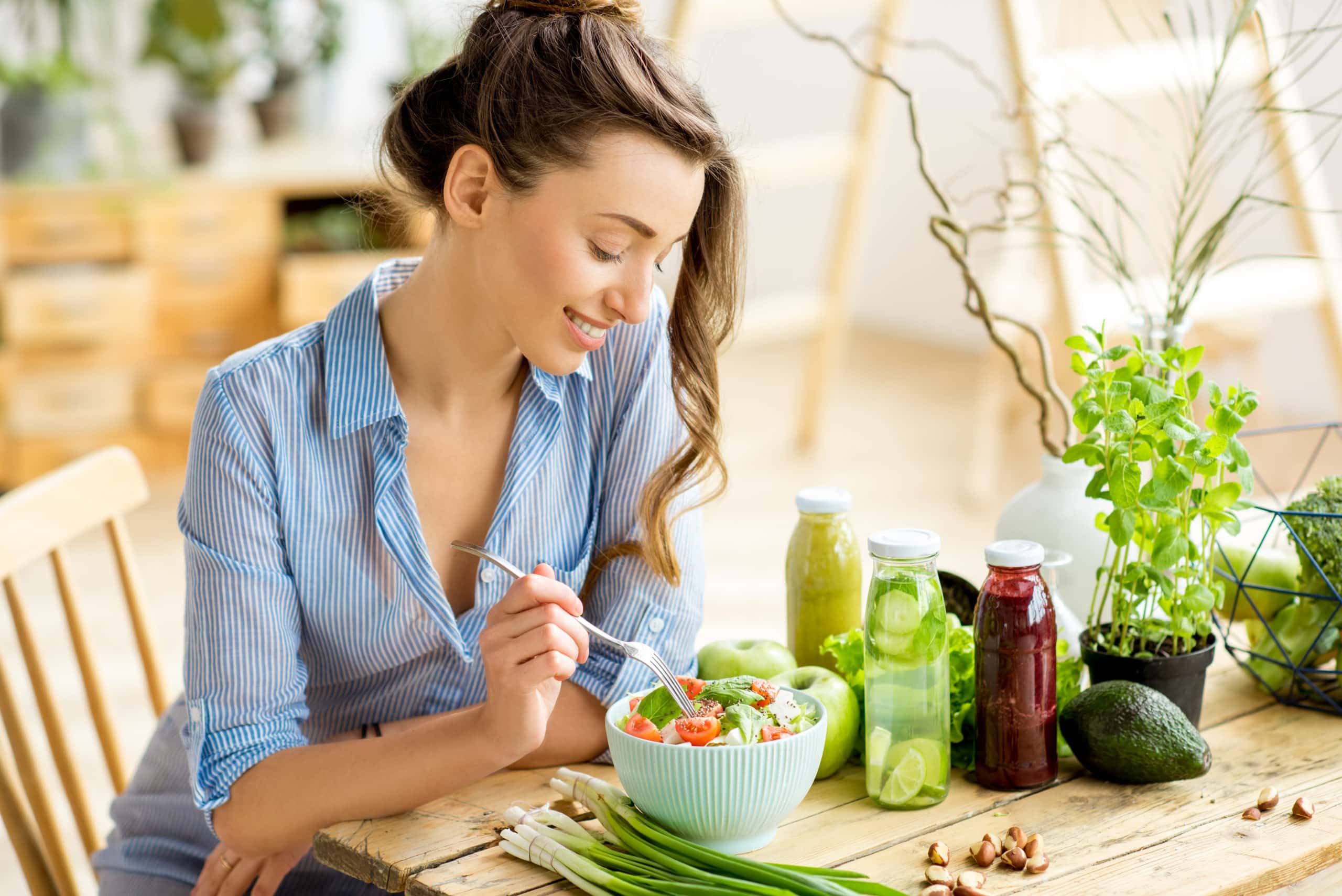 young and happy woman eating a salad