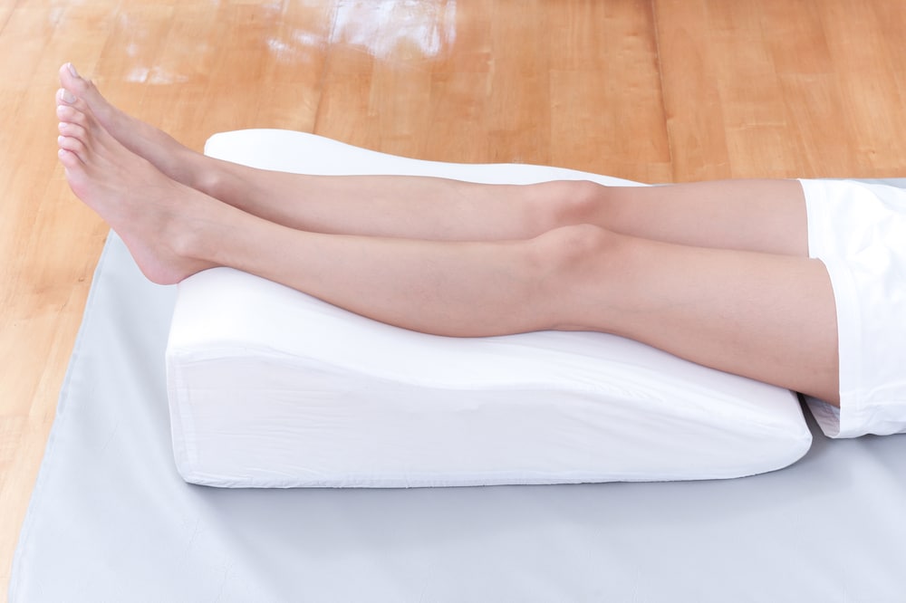 A Woman's Legs Lay Down On A Pillow For Relaxing