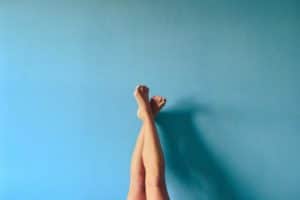 legs in front of a blue wall